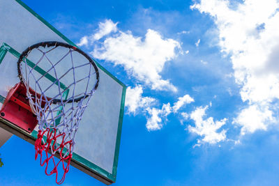 Low angle view of basketball hoop against blue sky