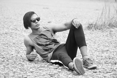 Full length of young man relaxing at beach