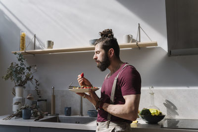 Young man looking at camera at home