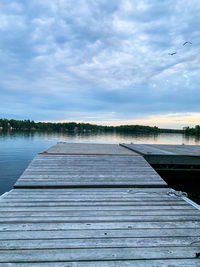 Pier over lake against sky