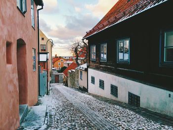 Cobbled street between buildings during winter