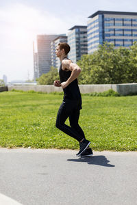 Full length of young man exercising on road