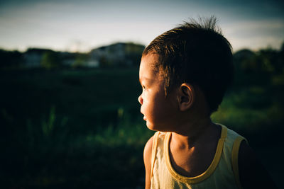 Close-up of boy against sky