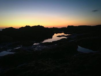 Silhouette of rocks on beach