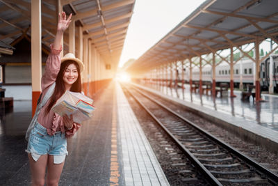 Woman standing on railroad station platform