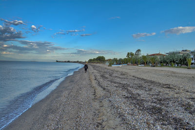 Scenic view of beach against blue sky