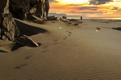 Scenic view of beach against sky during sunset