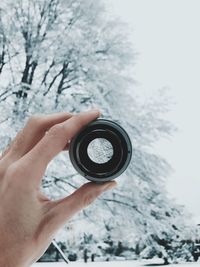 Close-up of human hand holding lens