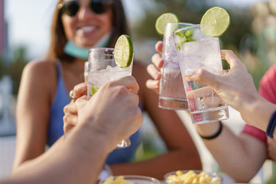 Close-up of friends toasting drinking glasses