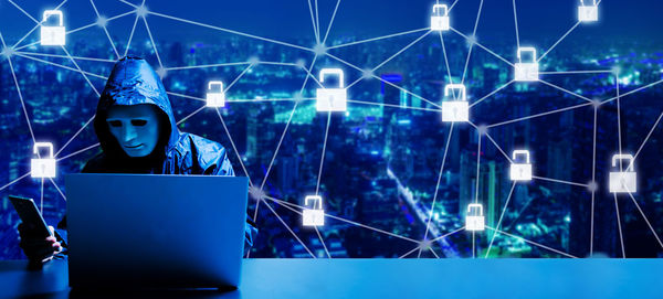 Low angle view of illuminated lighting equipment at night