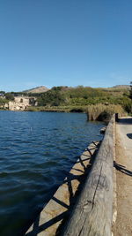 Scenic view of lake against clear blue sky