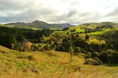 Scenic view of mountains against cloudy sky