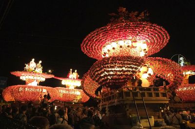 Low angle view of illuminated carousel at night