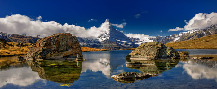 Panoramic view of lake and snowcapped mountains against sky