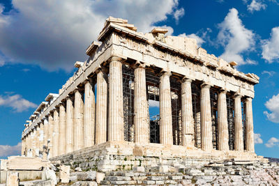 Low angle view of historical building against cloudy sky