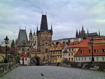 Hisotic bridge amidst buildings against sky in city