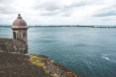 Scenic view of sea and buildings against sky