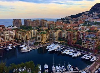 High angle view of buildings and harbor against sky