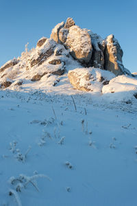 Scenic view of snowcapped mountain against clear blue sky