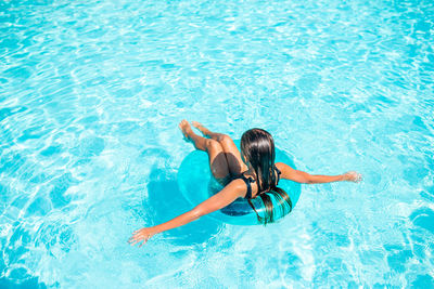 High angle view of girl swimming in pool