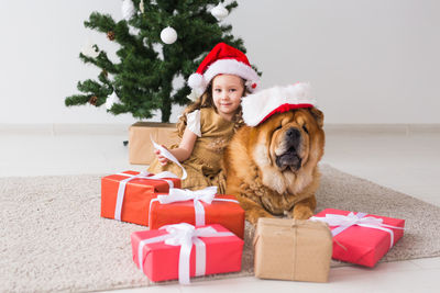 Portrait of man with dog sitting in box