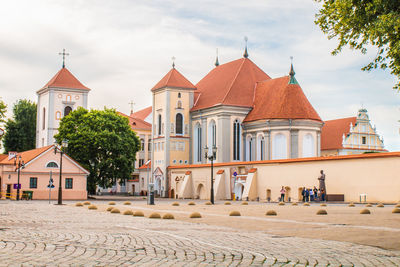 Exterior of houses against buildings in city against sky