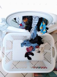 High angle view of clothes coming out from washing machine in basket