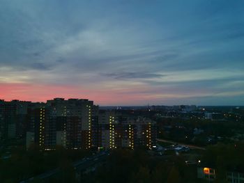 High angle view of illuminated buildings against sky at sunset