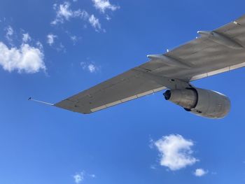 Low angle view of airplane flying against sky