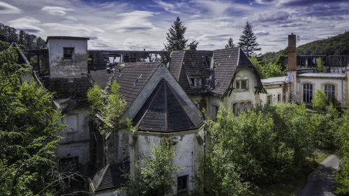 Panoramic view of old building and trees against sky