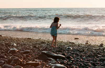 Little girl playing at the beach