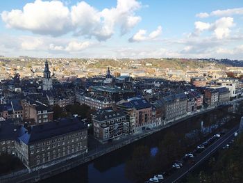 Aerial view of cityscape against cloudy sky