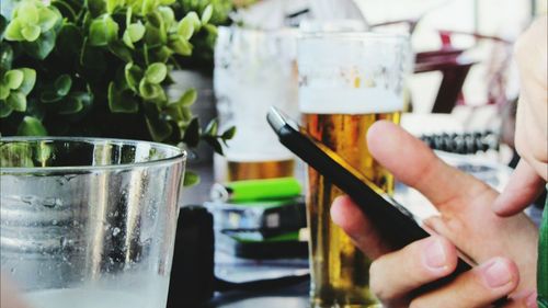 Close-up of hand holding beer glass