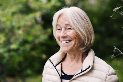 Happy senior woman looking away outdoors