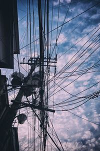 Low angle view of electricity pylon against sky