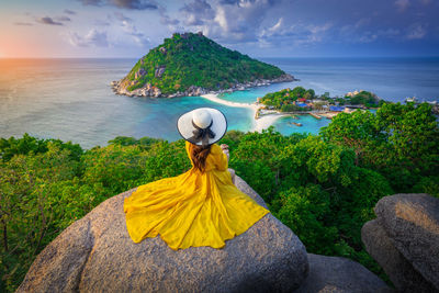 Rear view of woman looking at sea against sky