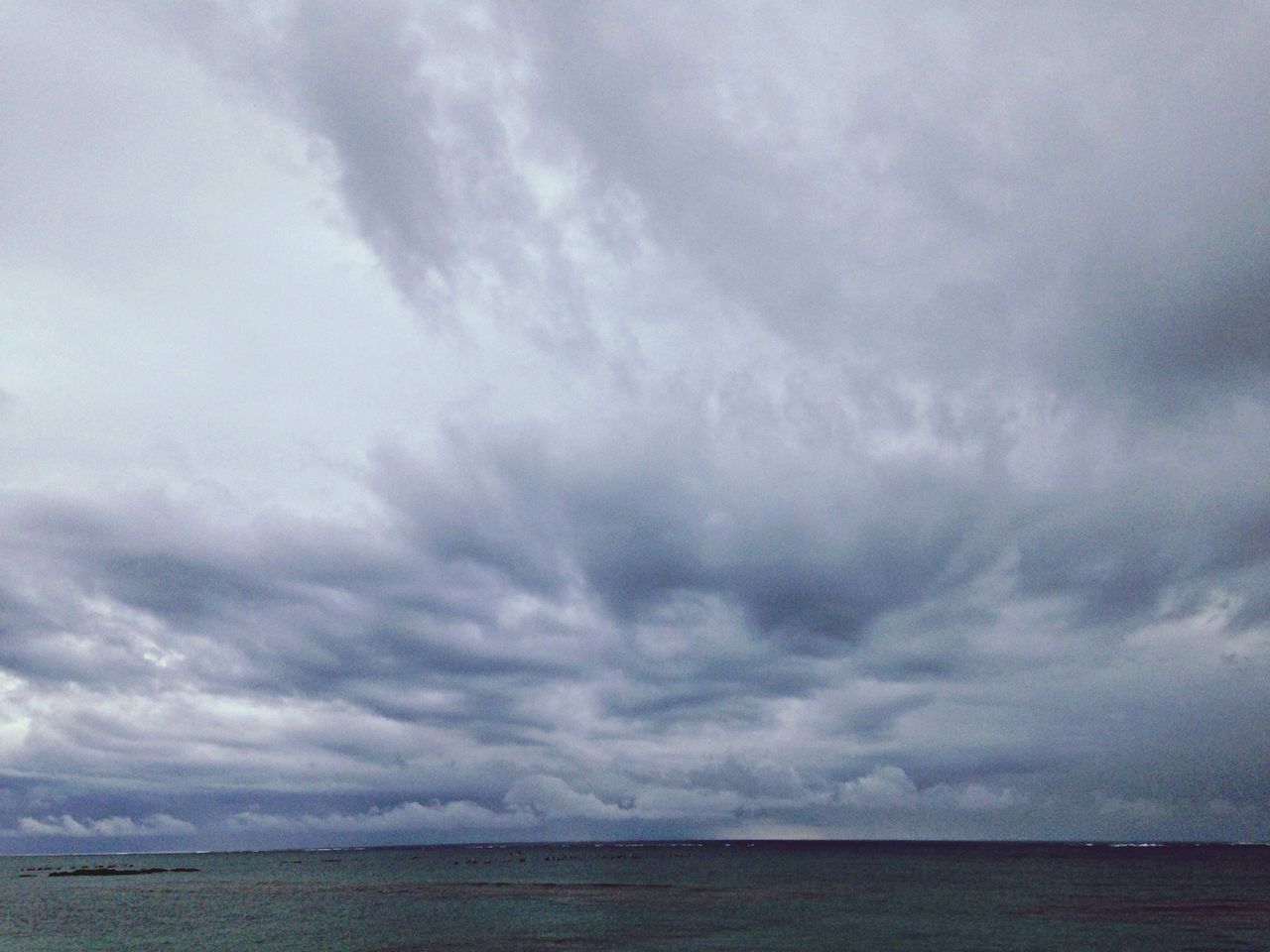 sky, sea, water, tranquil scene, tranquility, scenics, cloudy, cloud - sky, beauty in nature, horizon over water, waterfront, nature, weather, overcast, cloud, idyllic, storm cloud, cloudscape, remote, outdoors