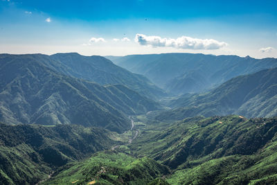 Misty mountain range covered with white mist and amazing blue sky