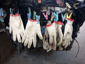 Close-up of gloves hanging outdoors