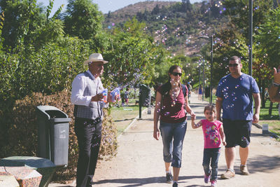 People walking along plants