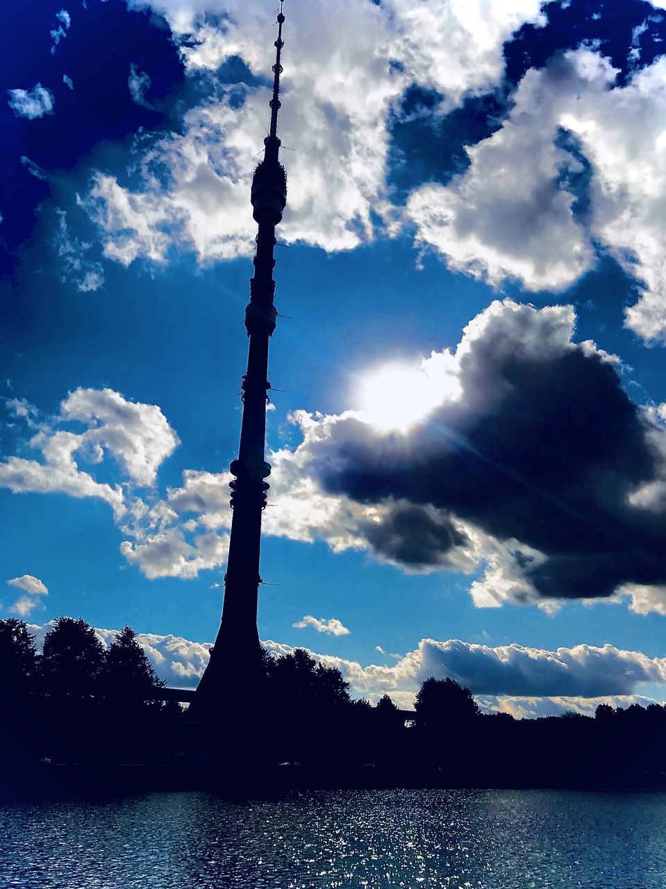 SILHOUETTE OF TOWER WITH REFLECTION IN LAKE