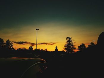 Silhouette of trees against sky at sunset