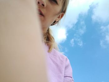 Low angle view of girl against sky