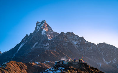 Scenic view of mountains against clear blue sky