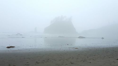 Scenic view of sea against sky during foggy weather