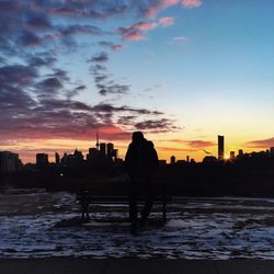 Silhouette of cityscape at sunset