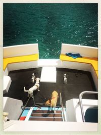 Birds perching on boat in sea