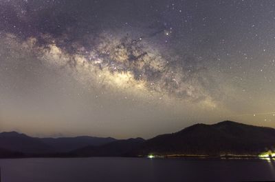 Scenic view of mountains against sky at night