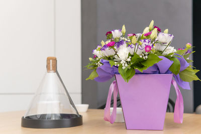 Close-up of purple flower vase on table