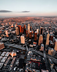 Aerial view of cityscape against sky during sunset